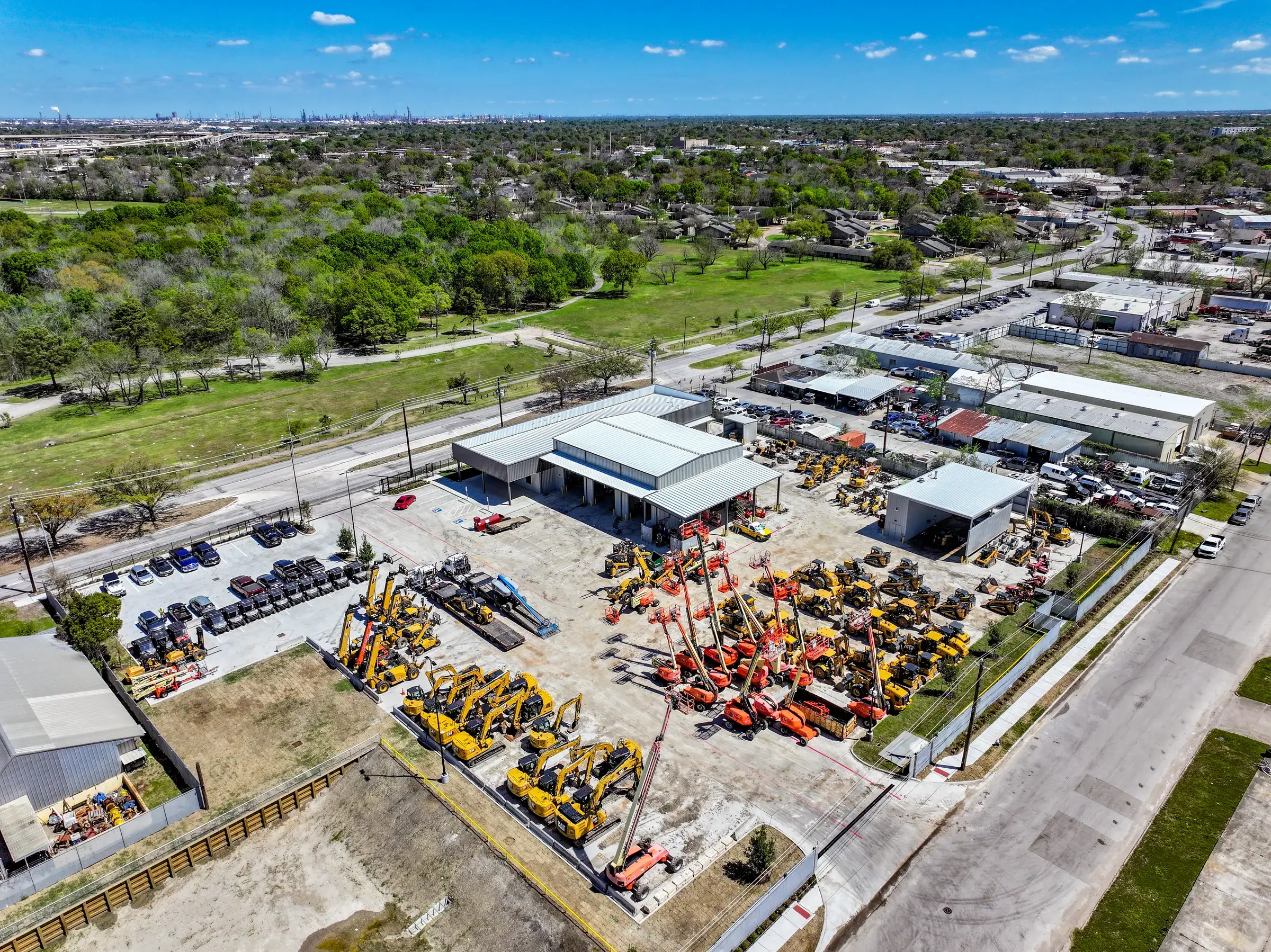 Wide aerial of the full property, buildings and yard laid out along Long Drive