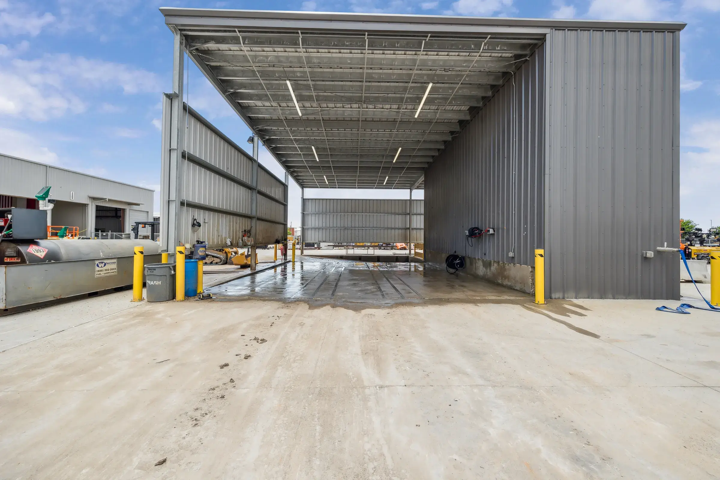 A covered drive-through bay open at both ends so equipment never has to back out