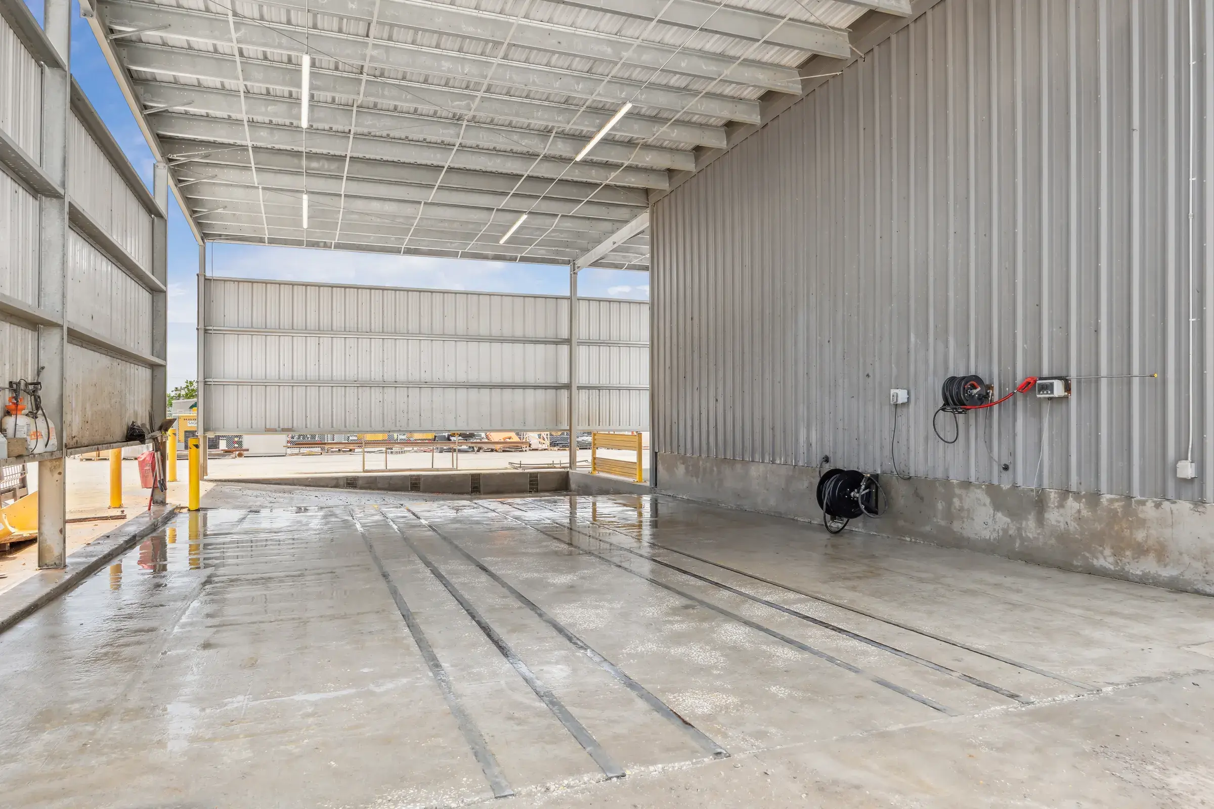 The wash bay, drains set into the slab and daylight through the far opening