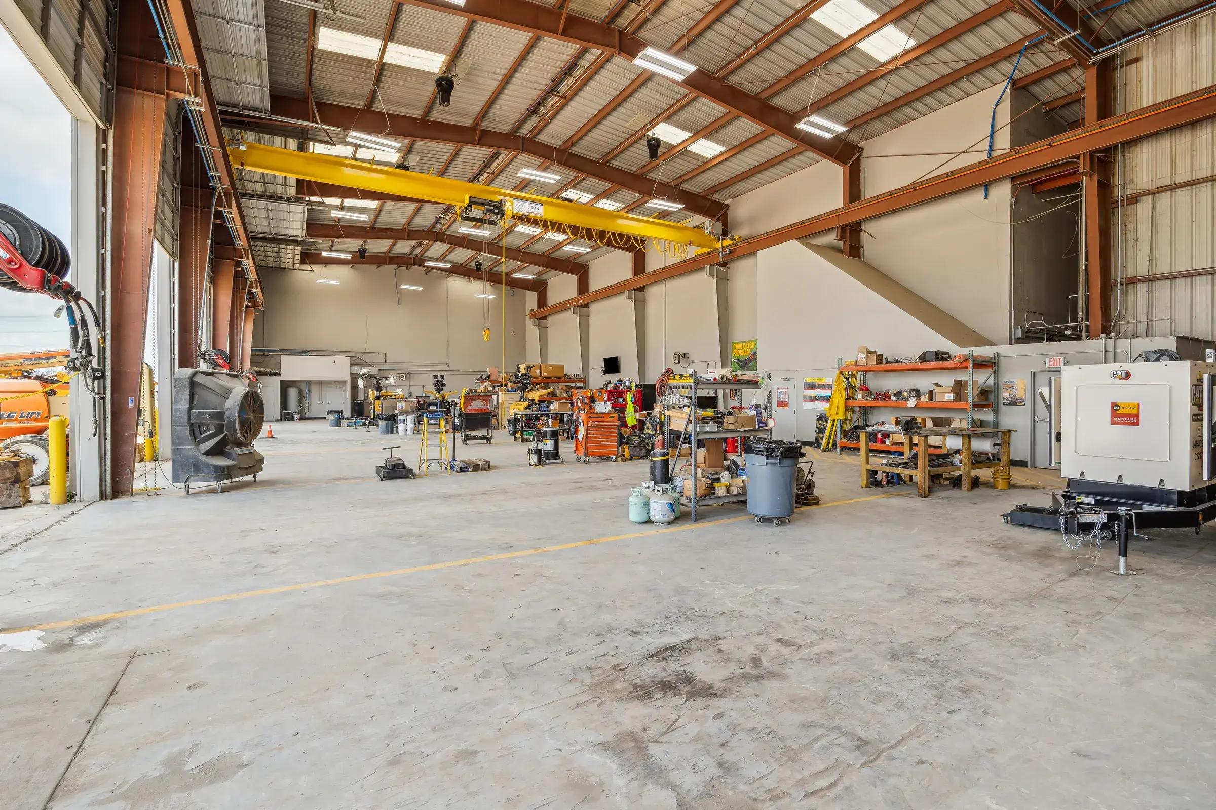 Wide view down the shop with equipment spread across the bays