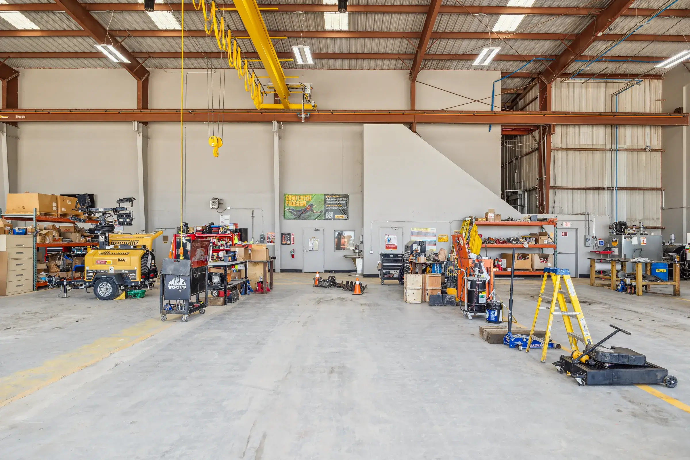 A repair bay mid-job, jacks and stands set out around the machines