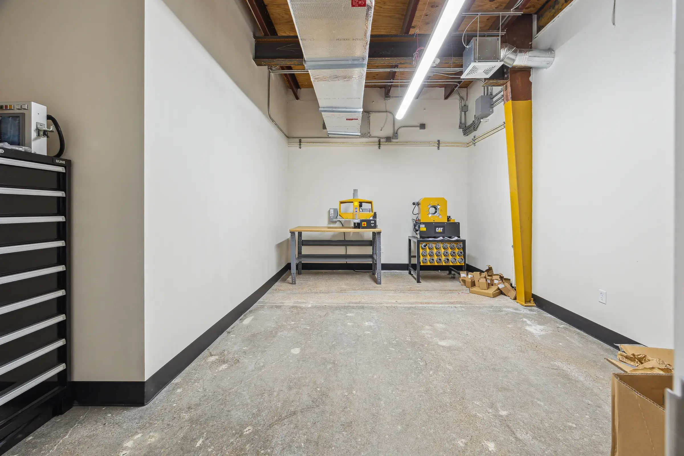 Tool storage and shelving lining the back of the service area