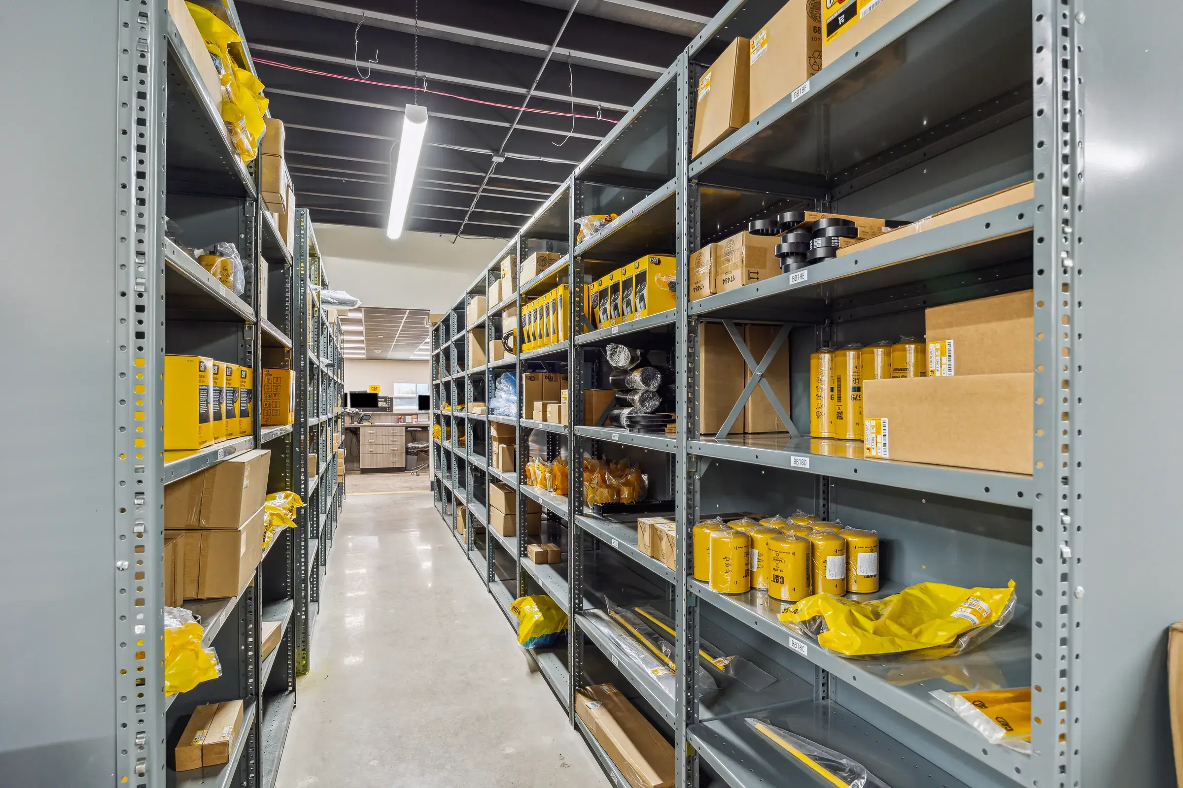 A parts racking aisle stocked to the ceiling