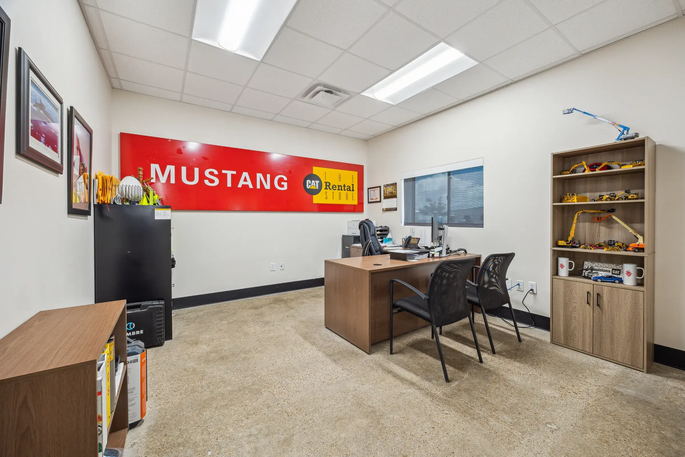 An office fitted out with the Mustang CAT banner behind the desk