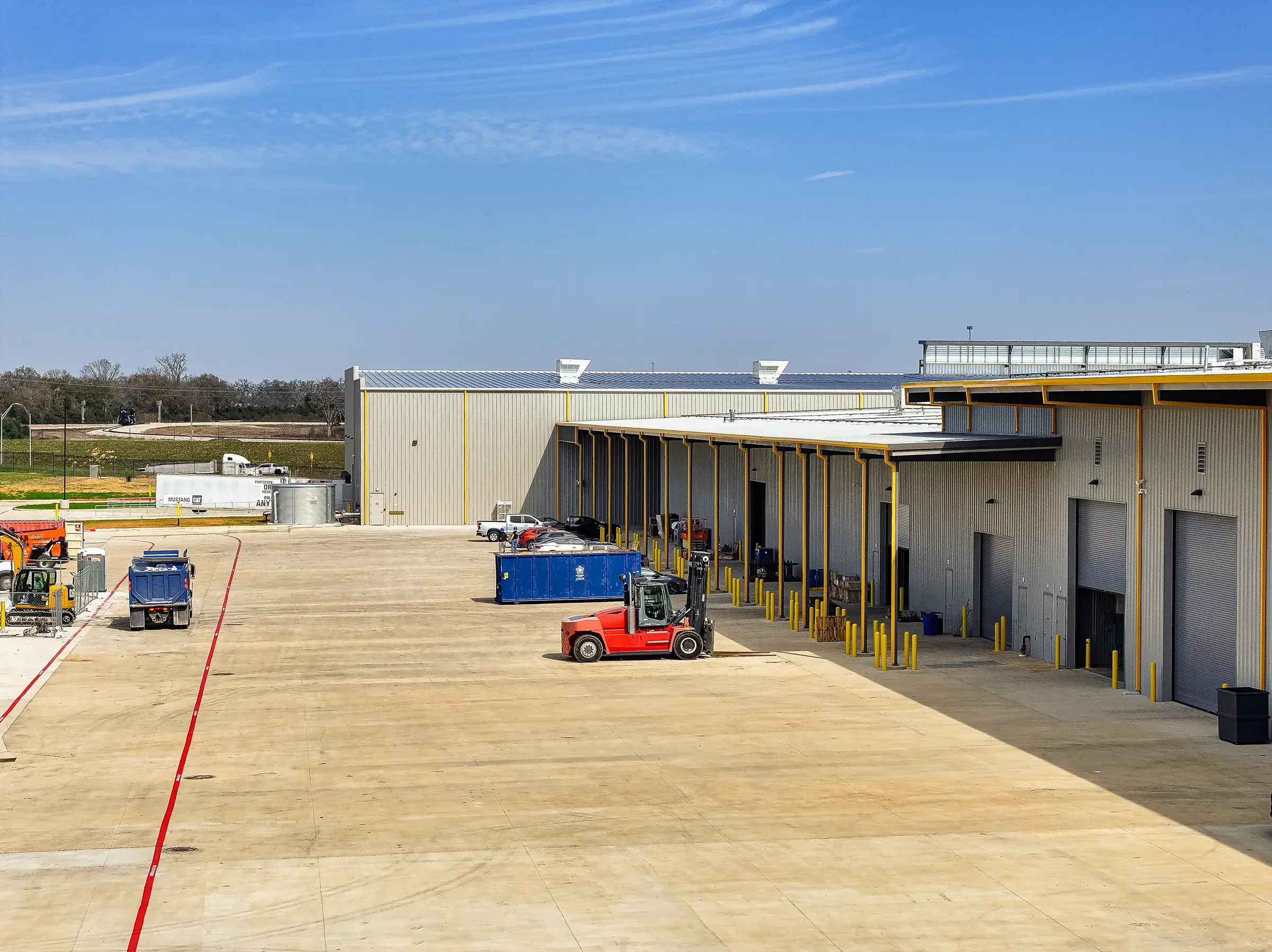 Open bays with a forklift and trailer working the apron