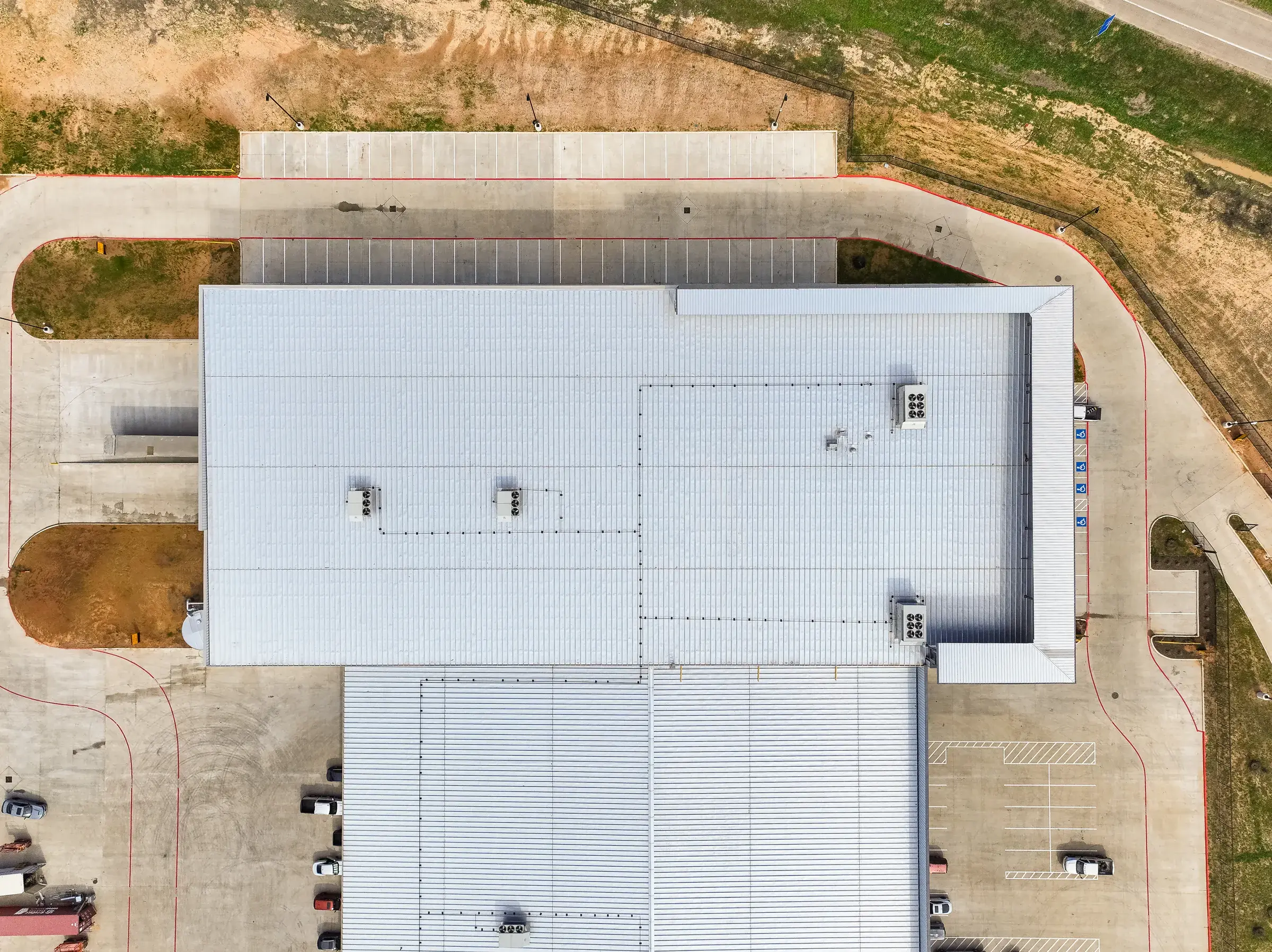 Top-down aerial of the building roof and the concrete apron wrapping it