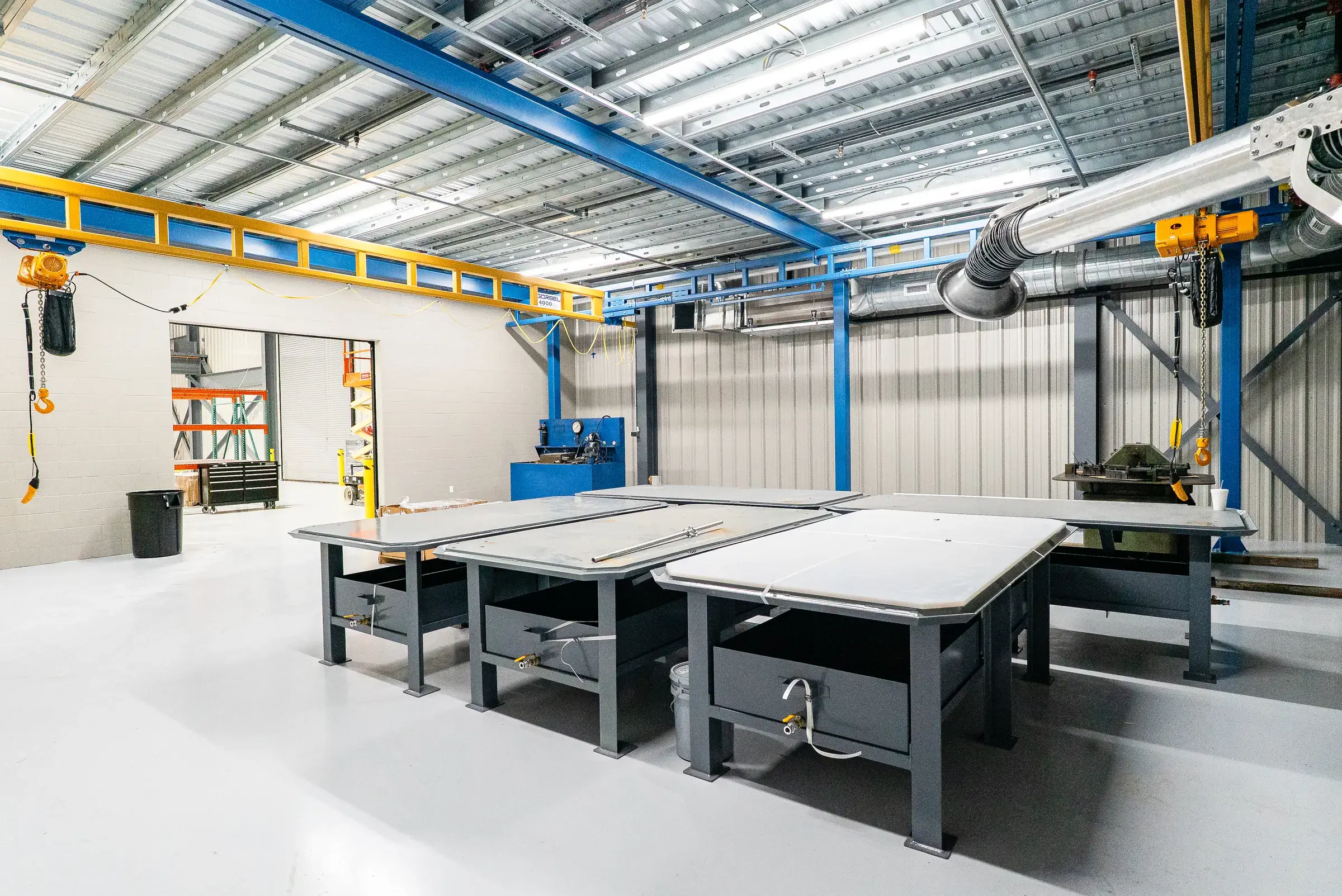 Steel workbenches set out under the blue crane rail