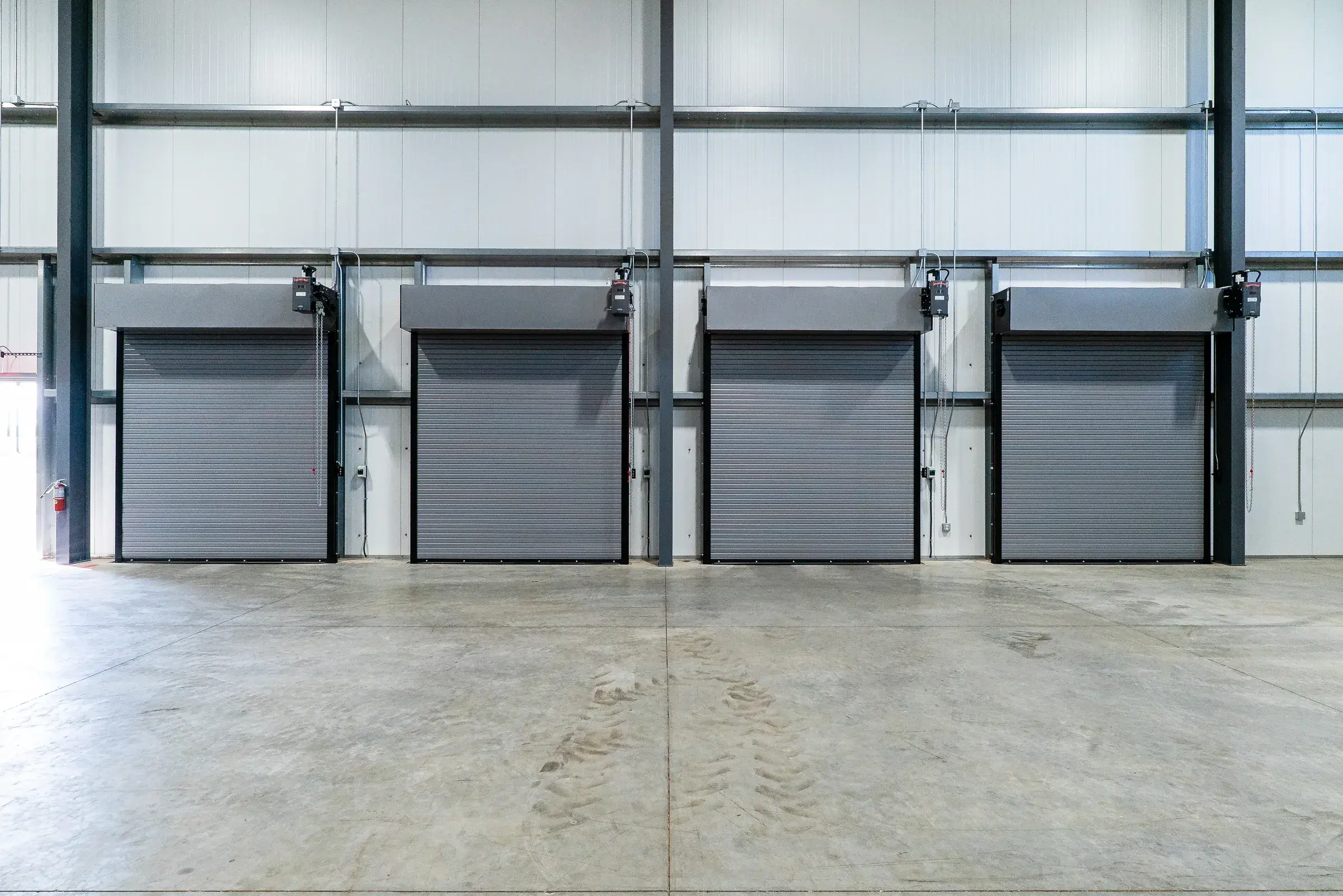 The dock doors from inside, a row of overhead doors along the wall