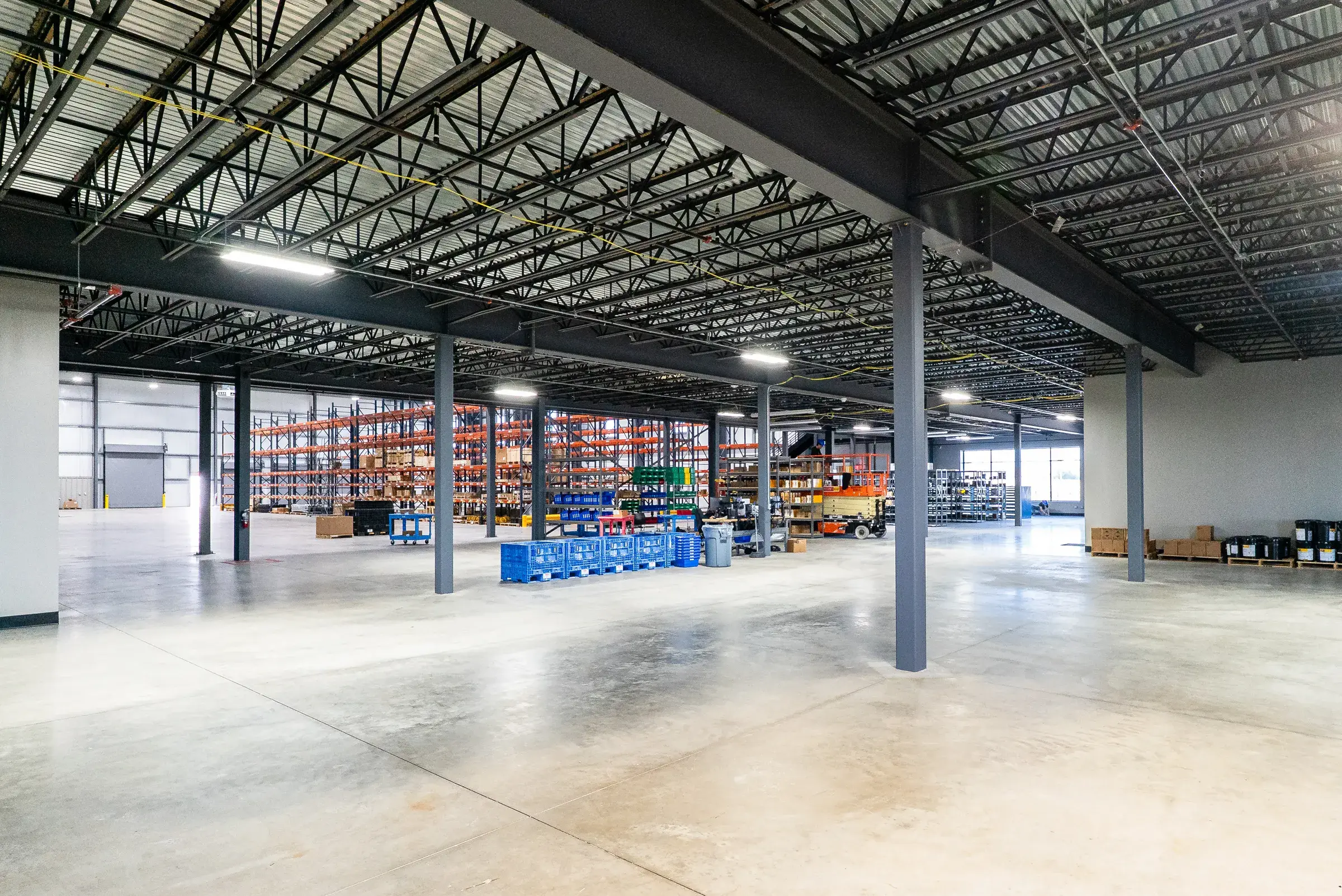 The warehouse floor with racking running back between the structural columns