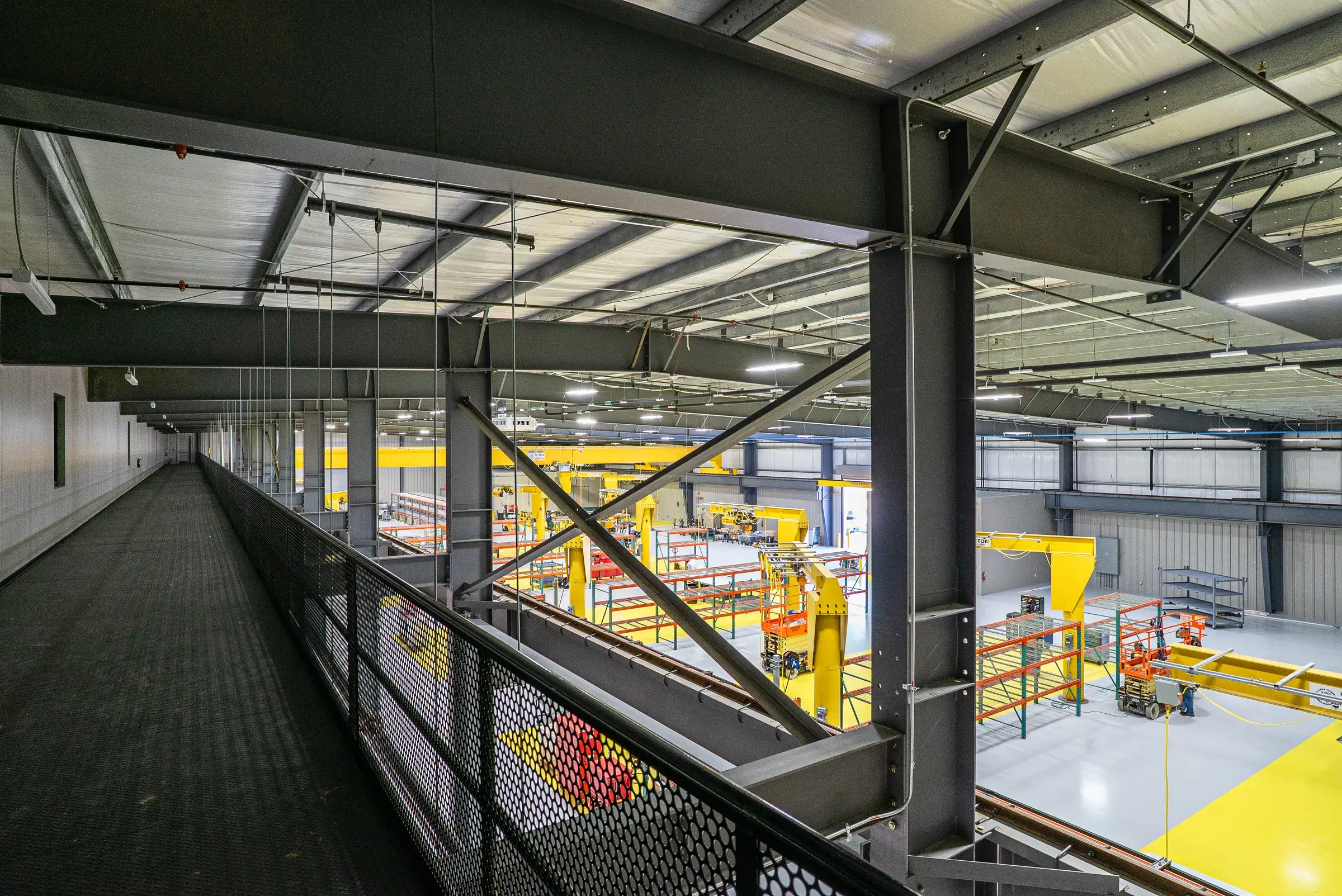The mezzanine catwalk running above the shop, connecting the office side to the work floor
