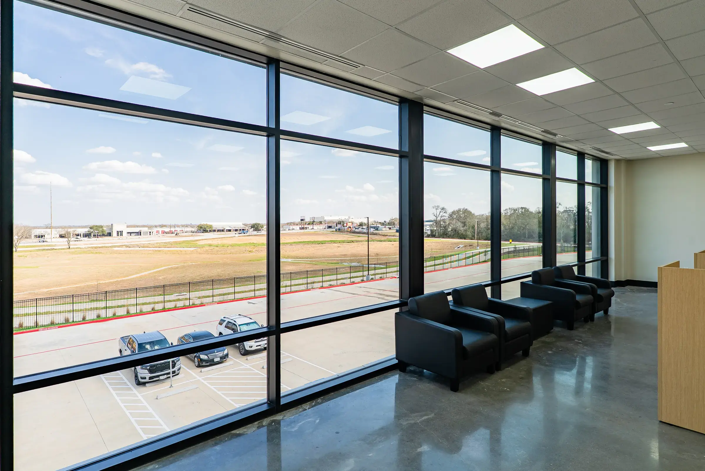 A seating area set along the office window wall