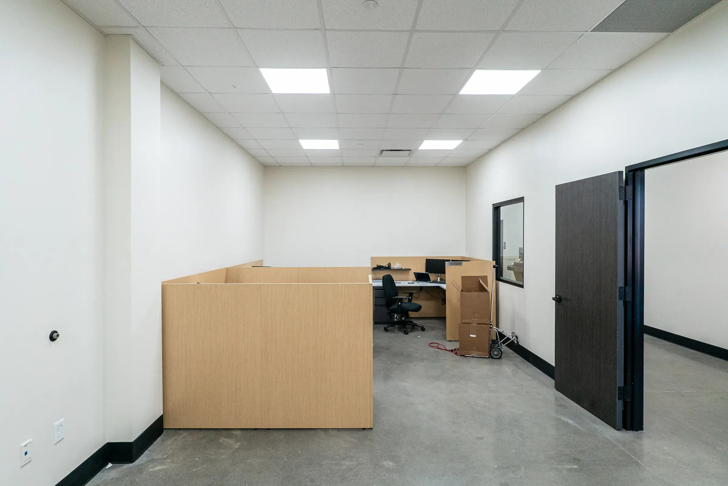 A quieter corner of the office fit-out with desks against the partition