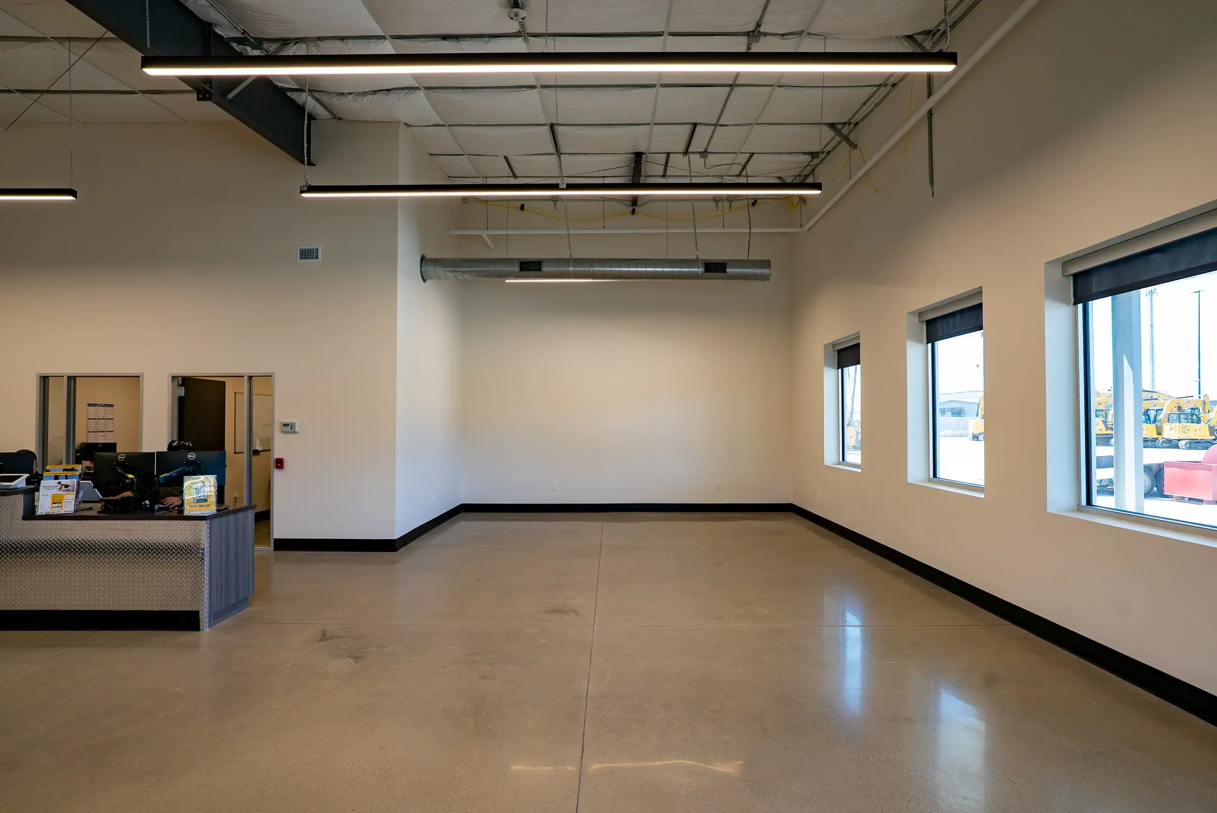 The finished interior with the service counter and daylight from the storefront glazing