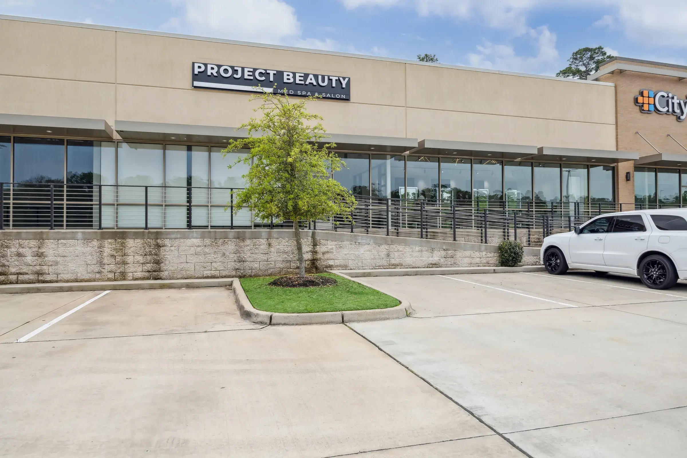 The Project Beauty storefront in its retail center, signage above the glazing