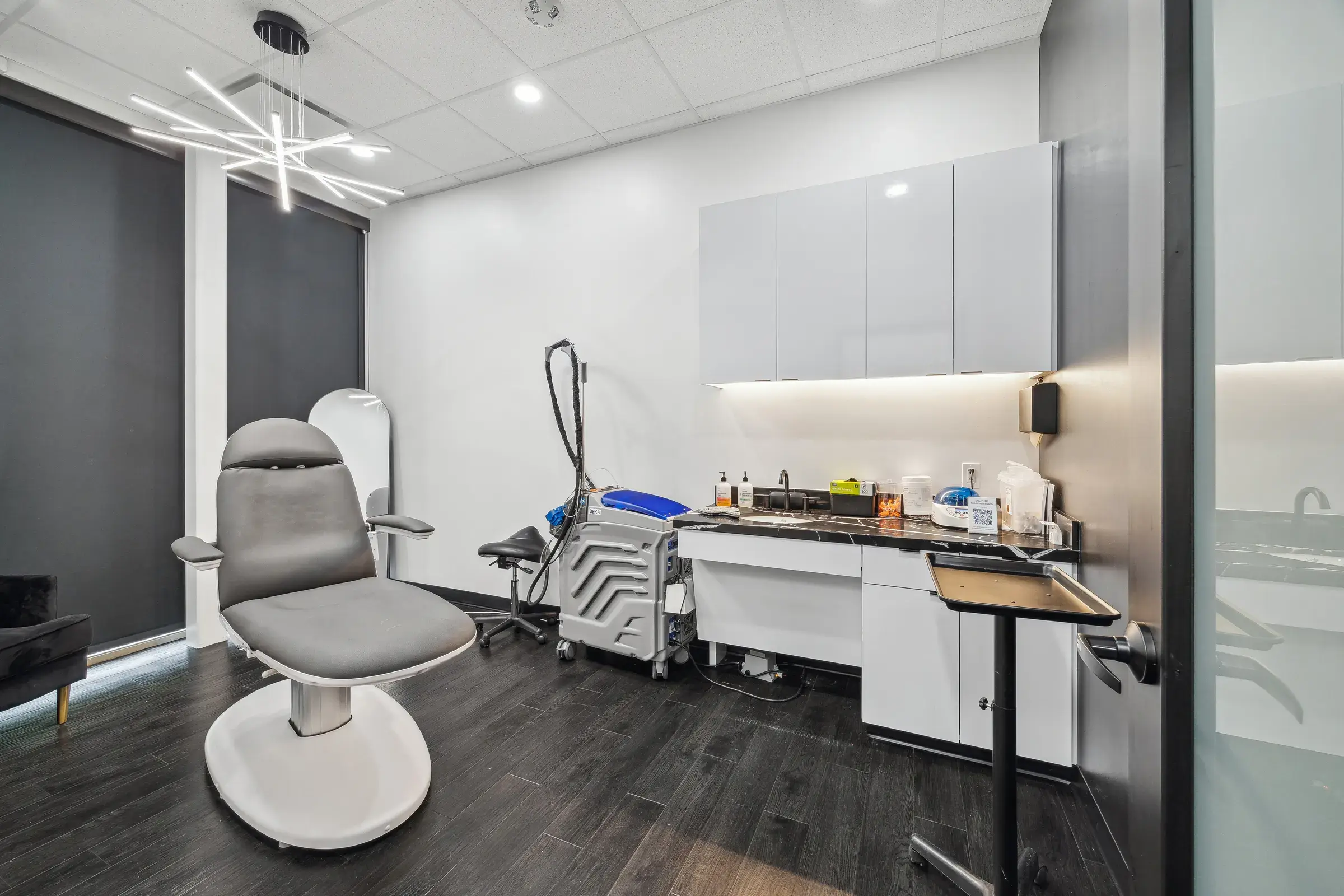 A treatment room fitted out with a med spa chair and built-in cabinetry