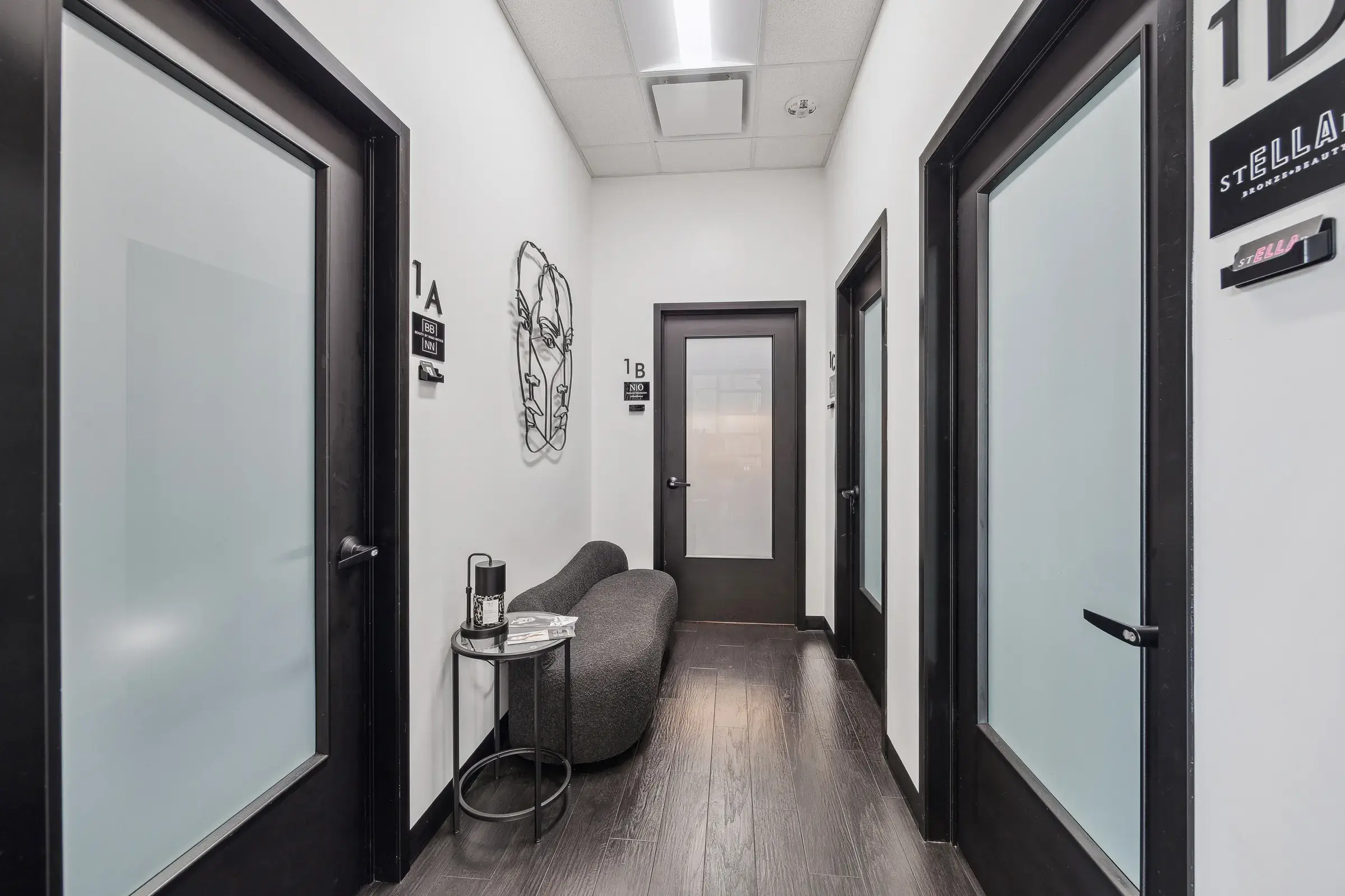 Suite doors along the corridor, each with its own tenant signage and a small seating nook