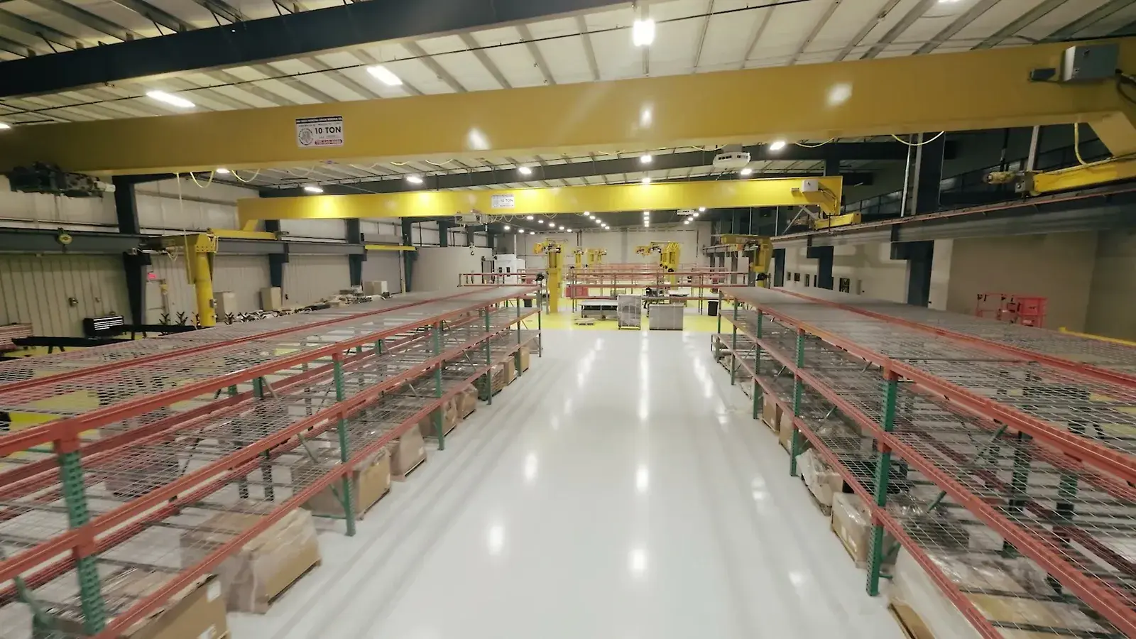 Drone walkthrough of the finished facility — the exterior approach, then through the shop, parts warehouse, and offices